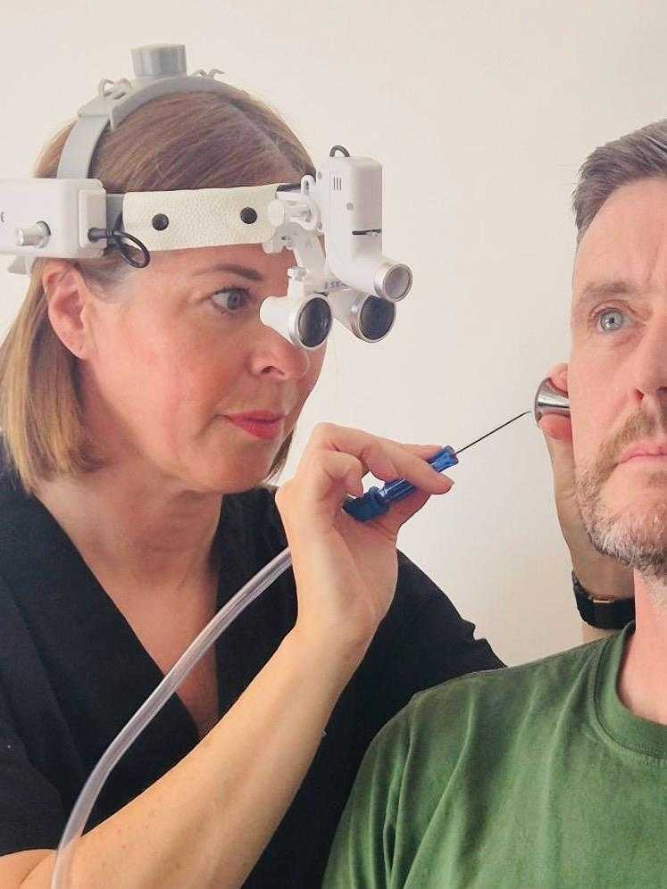 Chantal performing microsuction ear wax removal